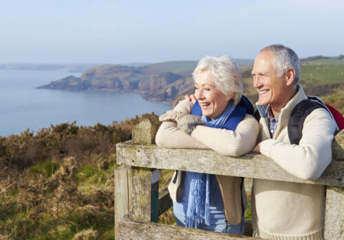 Senior Couple Walking Along Coastal Path